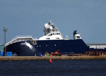 A large Navy research vessel that once belonged to late Microsoft billionaire Paul Allen tipped over — injuring 33 people — and is stuck at a 45 degree angle