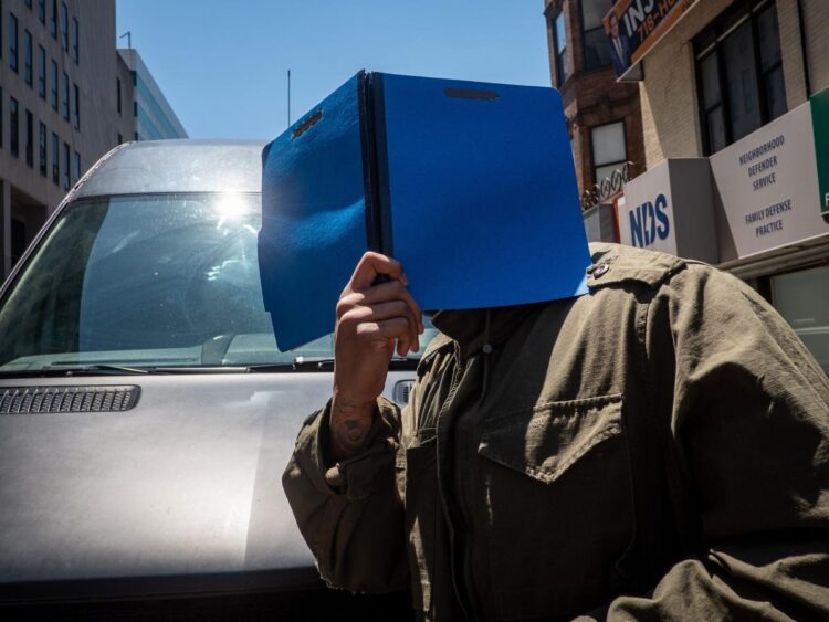 Rapper Flo Rida agrees to support package for his disabled son that could total nearly $500,000 a year, then left court holding a folder over his face