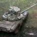 Russian Tank Debuts ‘Cope Cage’ Covered In Explosive Reactive Armor