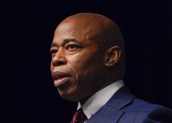 Law school graduates turn their backs on Adams during commencement address