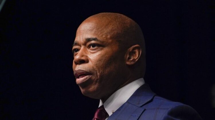 Law school graduates turn their backs on Adams during commencement address