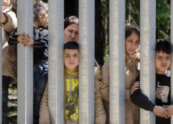 Migrants with children stuck at Poland’s border wall; activists say Belarus won’t let them turn back