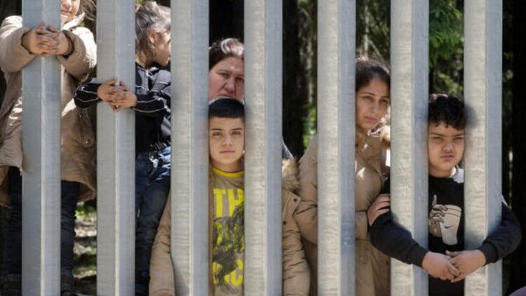 Migrants with children stuck at Poland’s border wall; activists say Belarus won’t let them turn back