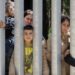Migrants with children stuck at Poland’s border wall; activists say Belarus won’t let them turn back