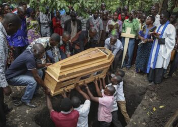 Ugandan border town buries victims of rebel massacre that left 42 dead, mostly students