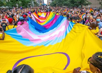 A Pride event protester who took a selfie with a terminally ill patient has been charged with criminal harassment, police say