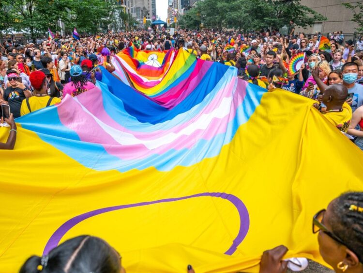 A Pride event protester who took a selfie with a terminally ill patient has been charged with criminal harassment, police say