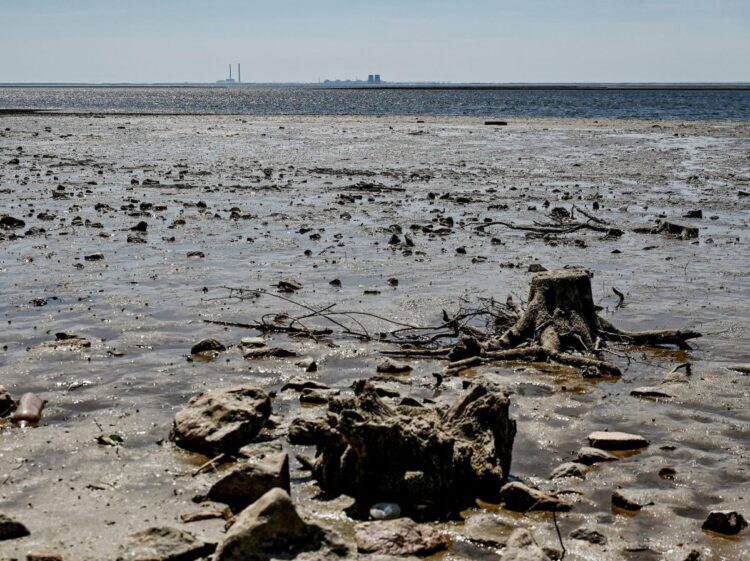 Draining reservoir from Ukraine’s destroyed dam is revealing World War II weapons