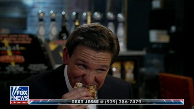 Ron DeSantis Says The Left Doesn’t ‘Want People to Be Happy,’ Then Awkwardly Eats Pizza (Video)