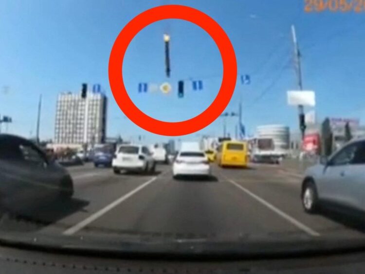 Dashcam footage shows the terrifying moment part of a missile narrowly misses a moving car in Kyiv