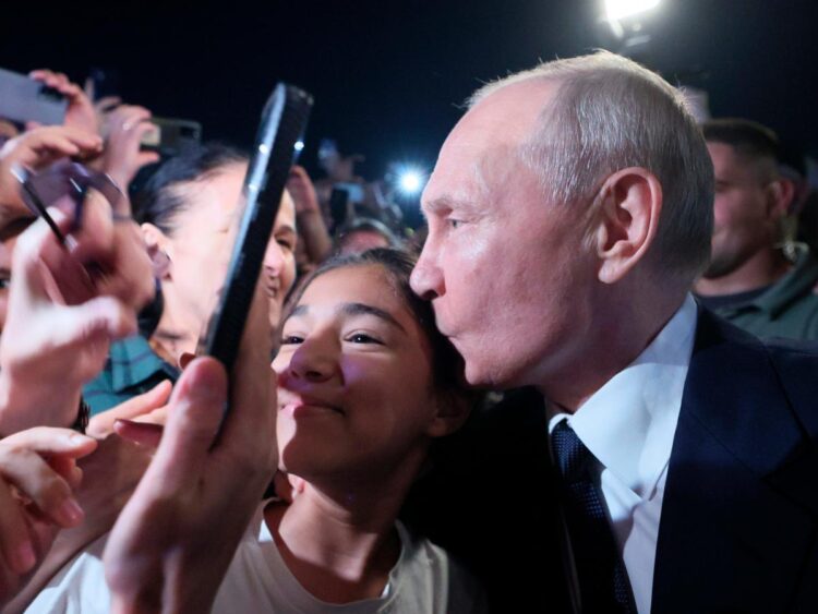 Putin, a germaphobe known for meeting with people at ridiculously long tables, took selfies kissing regular Russians this week
